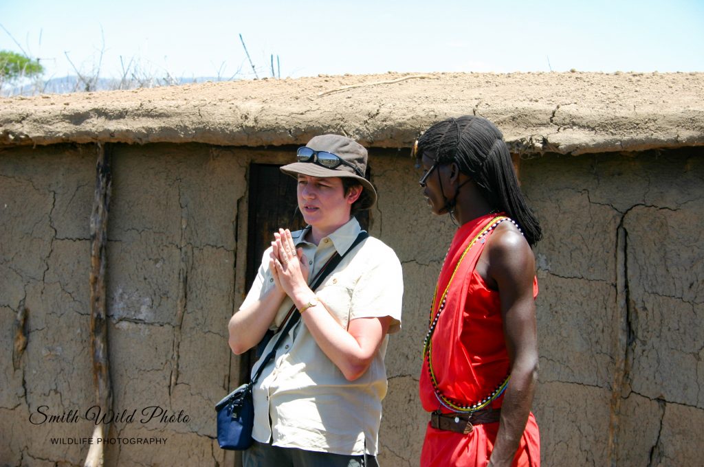 Woman and Masai warrior outside a Masai hut