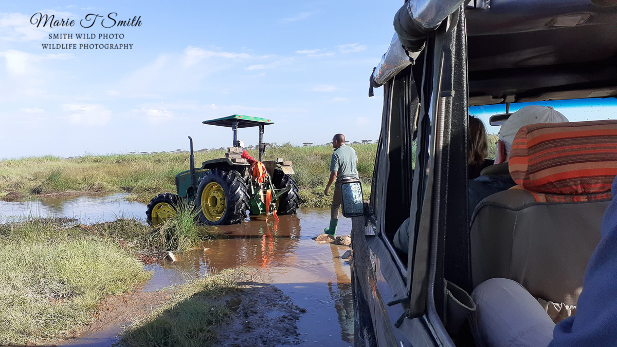 tractor and vehicle crossing ford in Africa